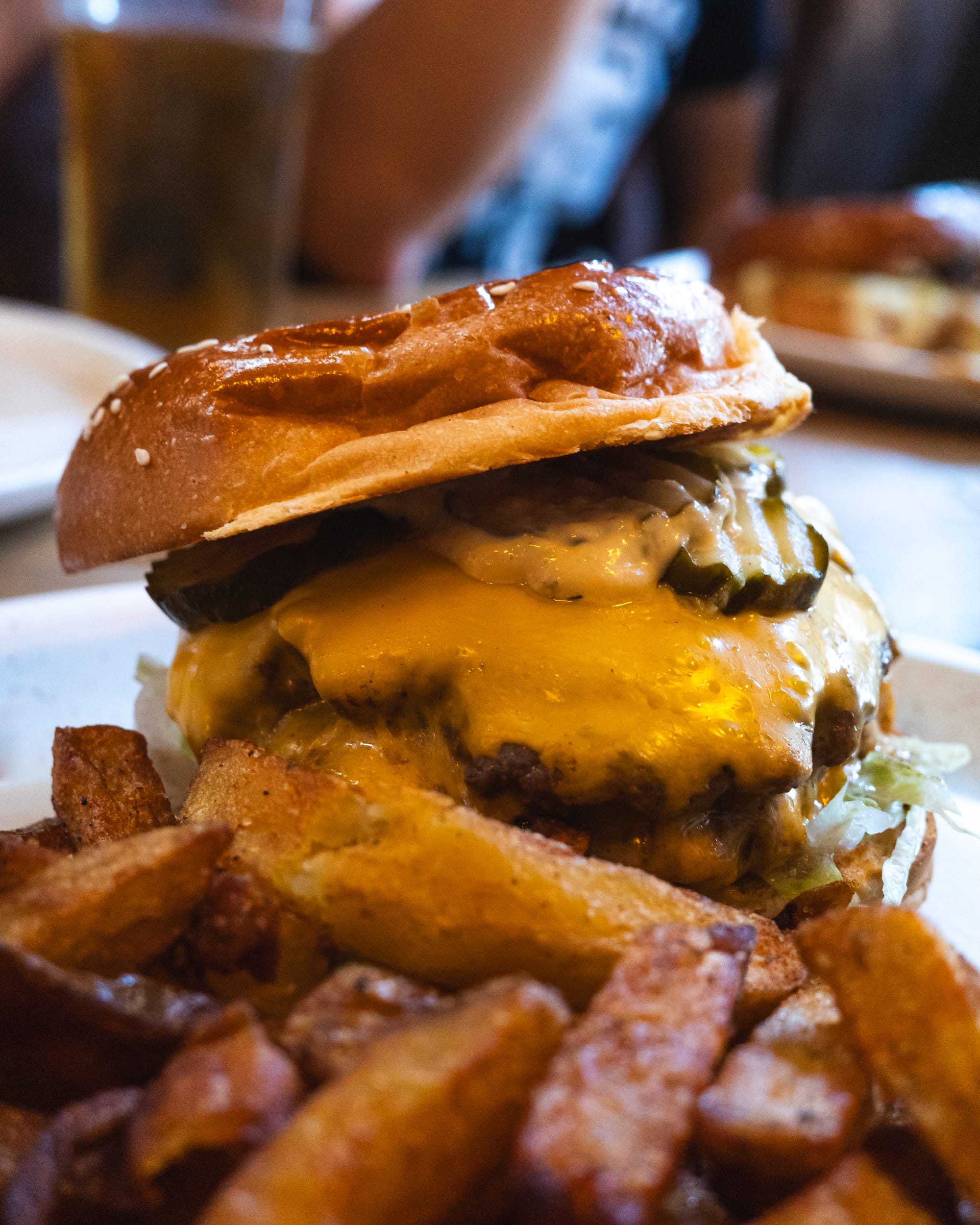 Close up shot of cheeseburger and chips