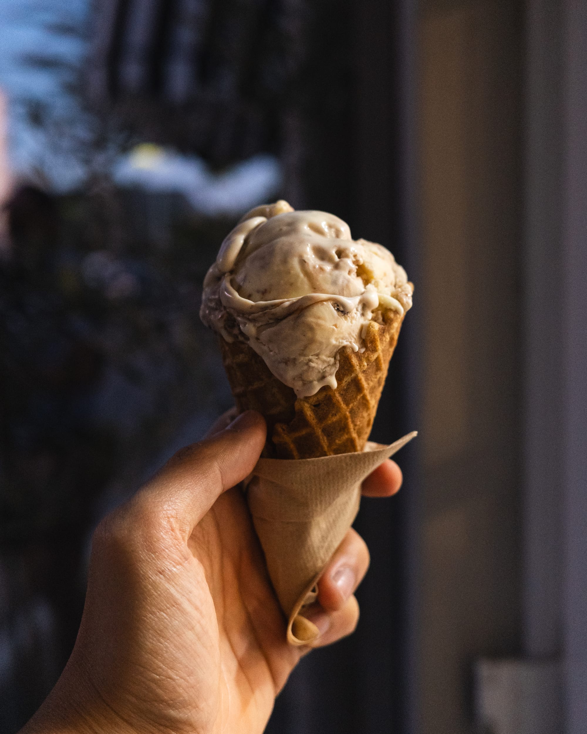 Hand holding ice-cream in a cone