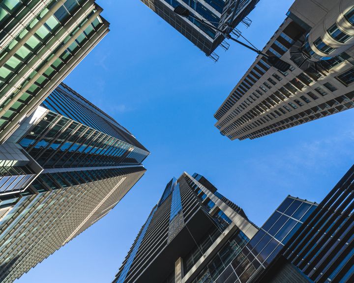 Shot looking up into the sky, surrounded by high rise buildings