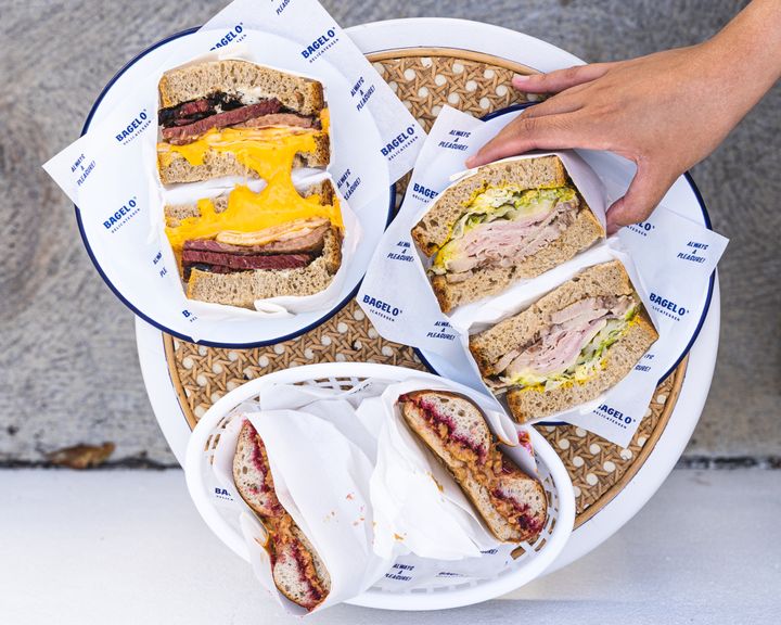 Overhead shot of hand reaching for a sandwich 