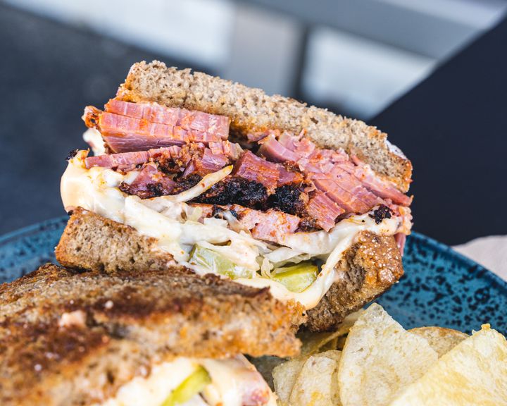 Close up of reuben sandwich with smoked pastrami and crisps