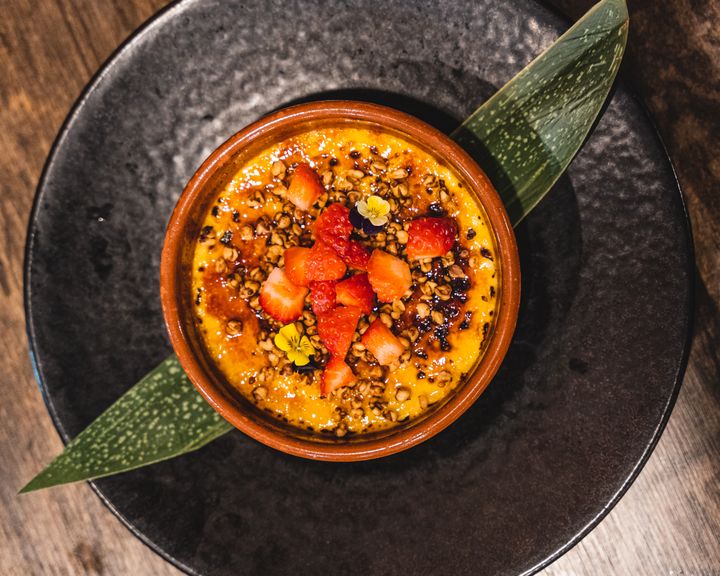 Top down shot of creme brulee topped with fruit