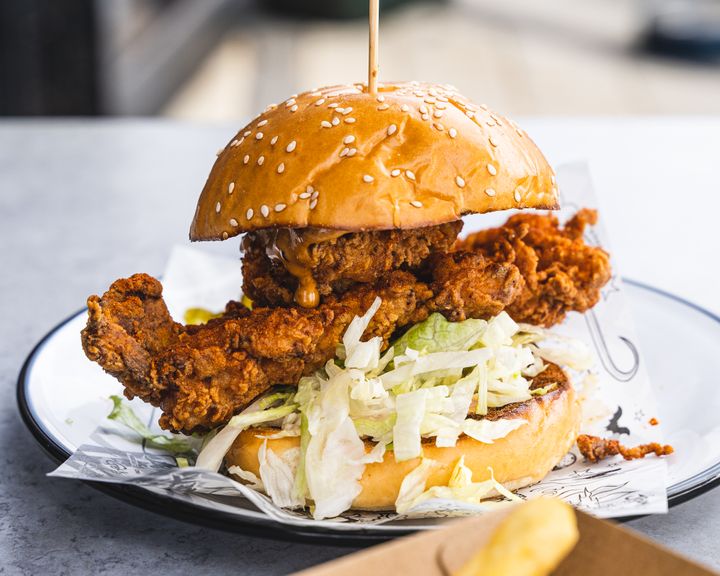 Close up of fried chicken burger with lettuce